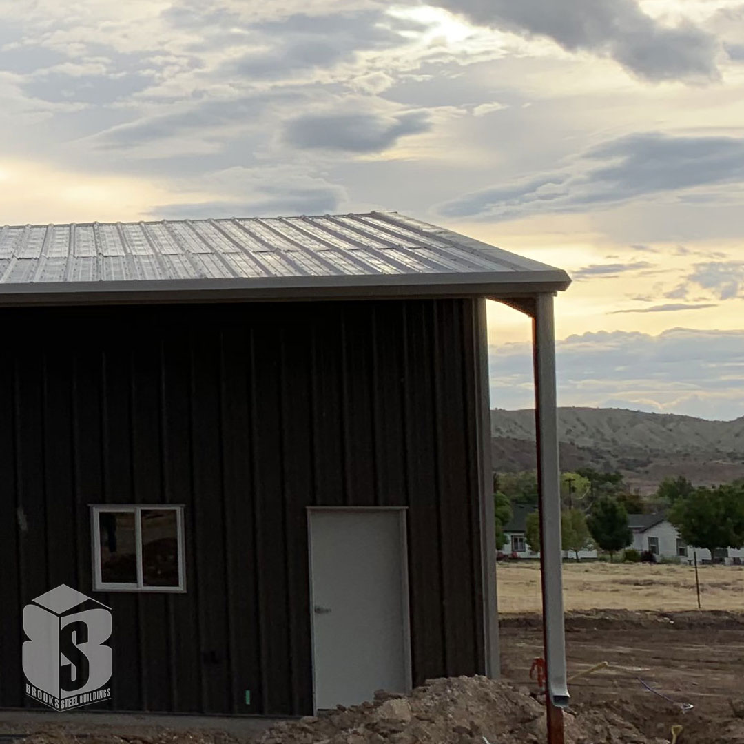 Steel outbuilding with walk door